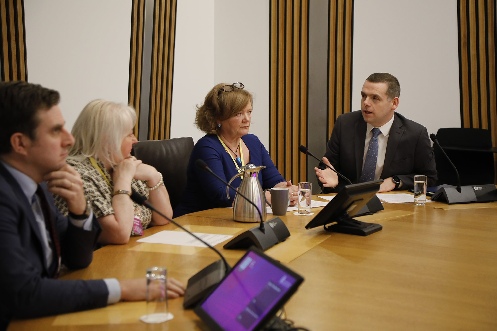 A picture of Daniel Johnson MSP, who introduced the Restraint and Seclusion in Schools (Scotland) Bill, Beth Morrison and Kate Sanger, who have campaigned on these issues for several years, sitting alongside the Convener, Douglas Ross MSP.